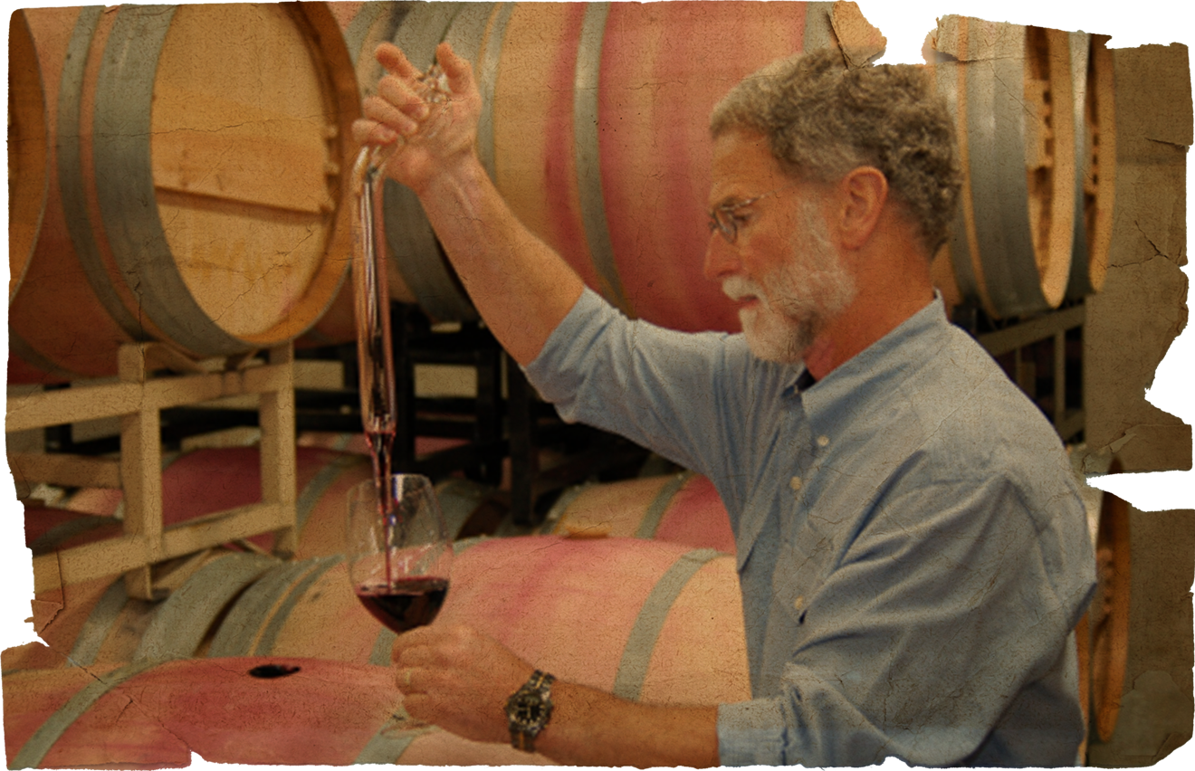 Bob Betz pouring wine from a barrel